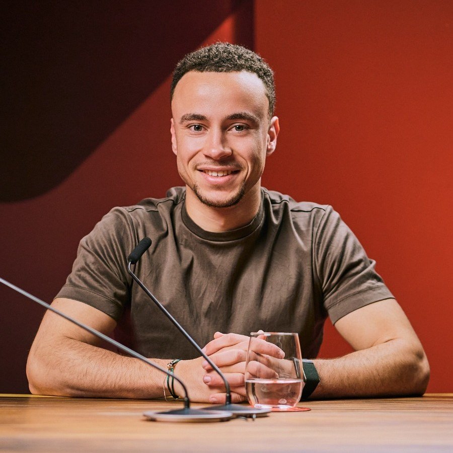 Sylvain Sedney of Fishuals at a table, with two microphones in front of him
